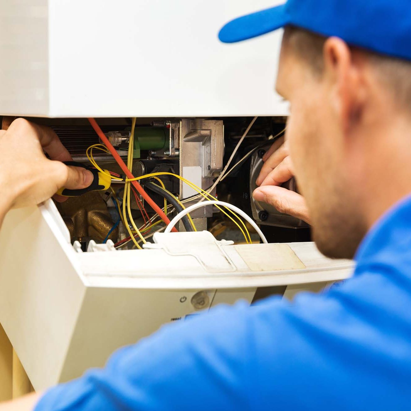 Maintenance service engineer working with home gas heating boiler